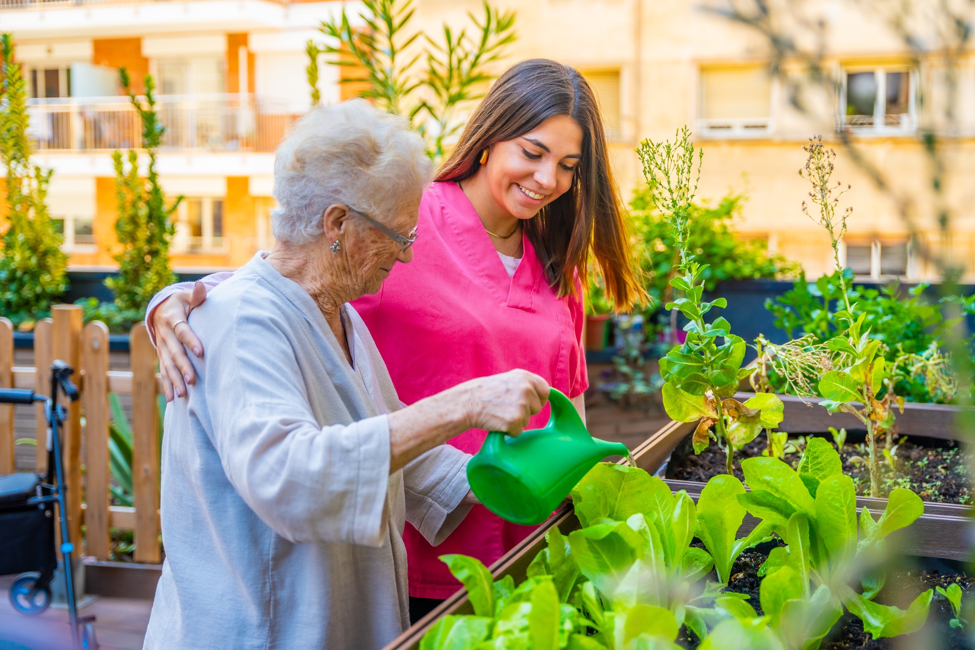 NDIS caregiver assisting an elderly woman with gardening, providing home-based personalized care with Community nursing care NDIS