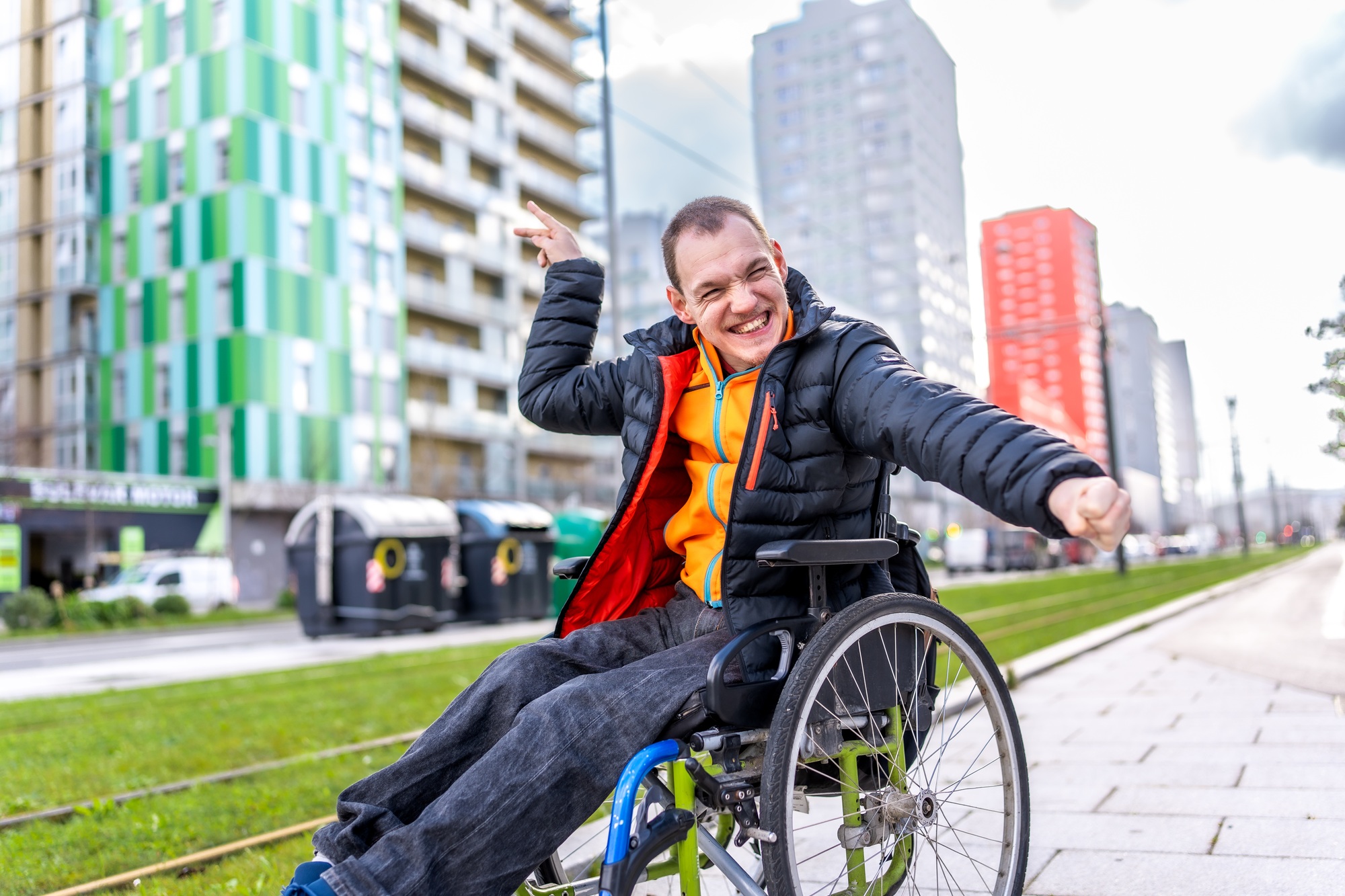 Smiling man in a wheelchair outdoors, symbolizing inclusive employment opportunities supported by Care Compatible Australia's NDIS partnerships.