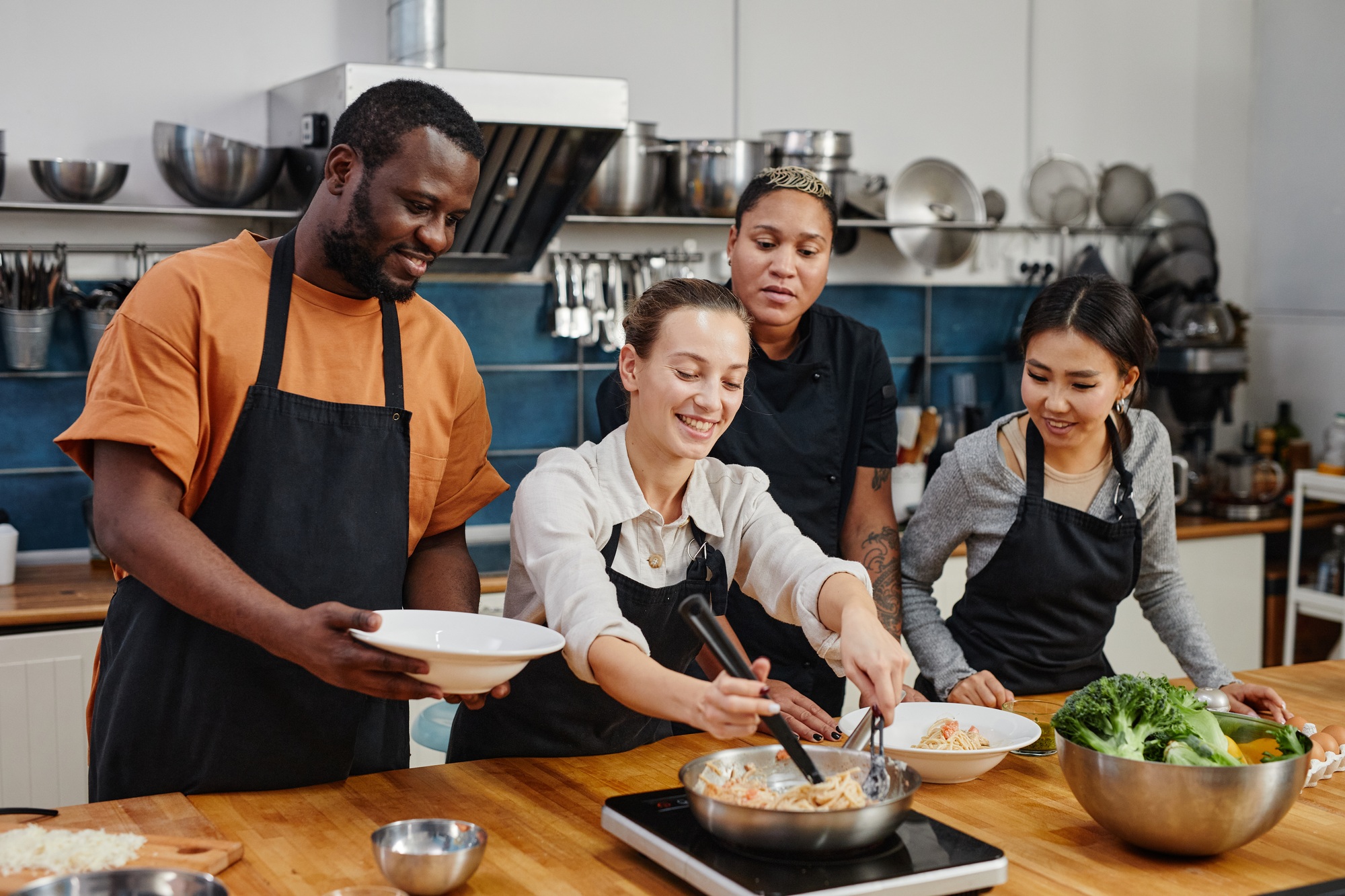 People Cooking Pasta in Workshop